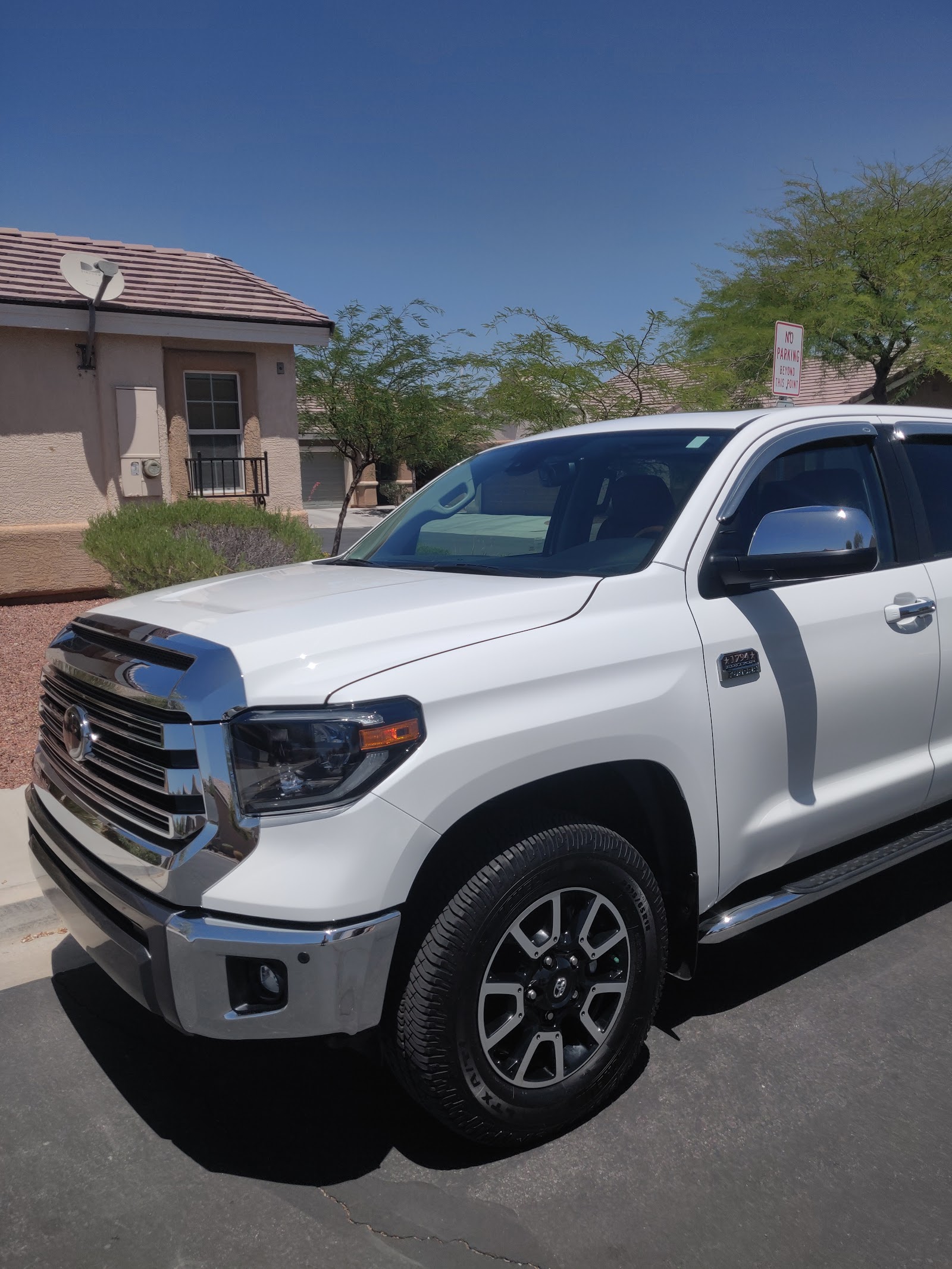 Clean white Toyota Tundra 1794 Edition parked after wash
