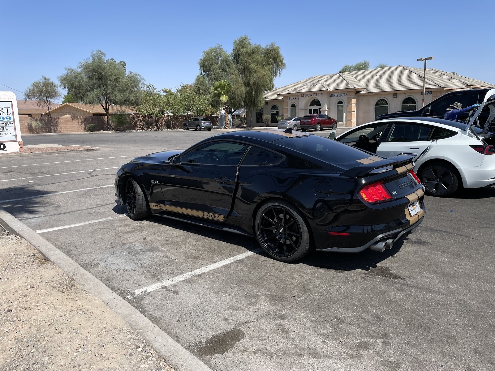 Clean black Shelby GT-H Mustang parked after wash